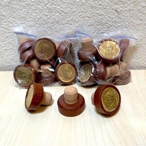 11 wood topped & cork bottle stoppers. From tequila bottles.